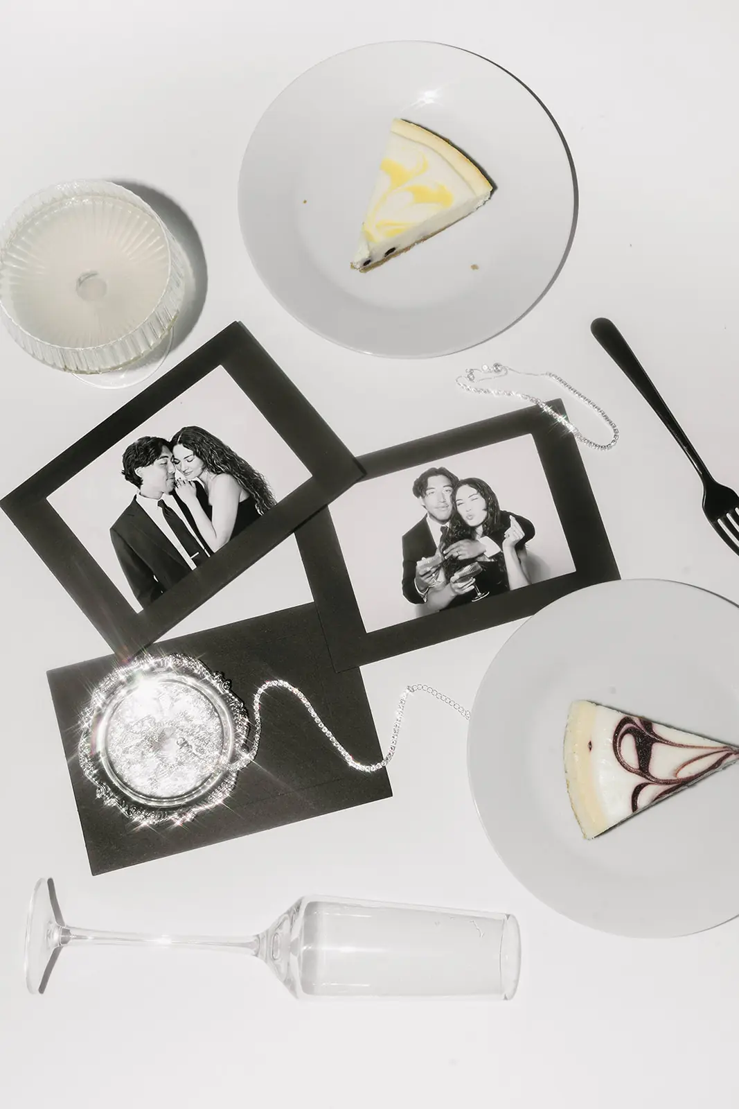 Black and white Glam photo booth portraits of a couple, laid out with champagne and dessert