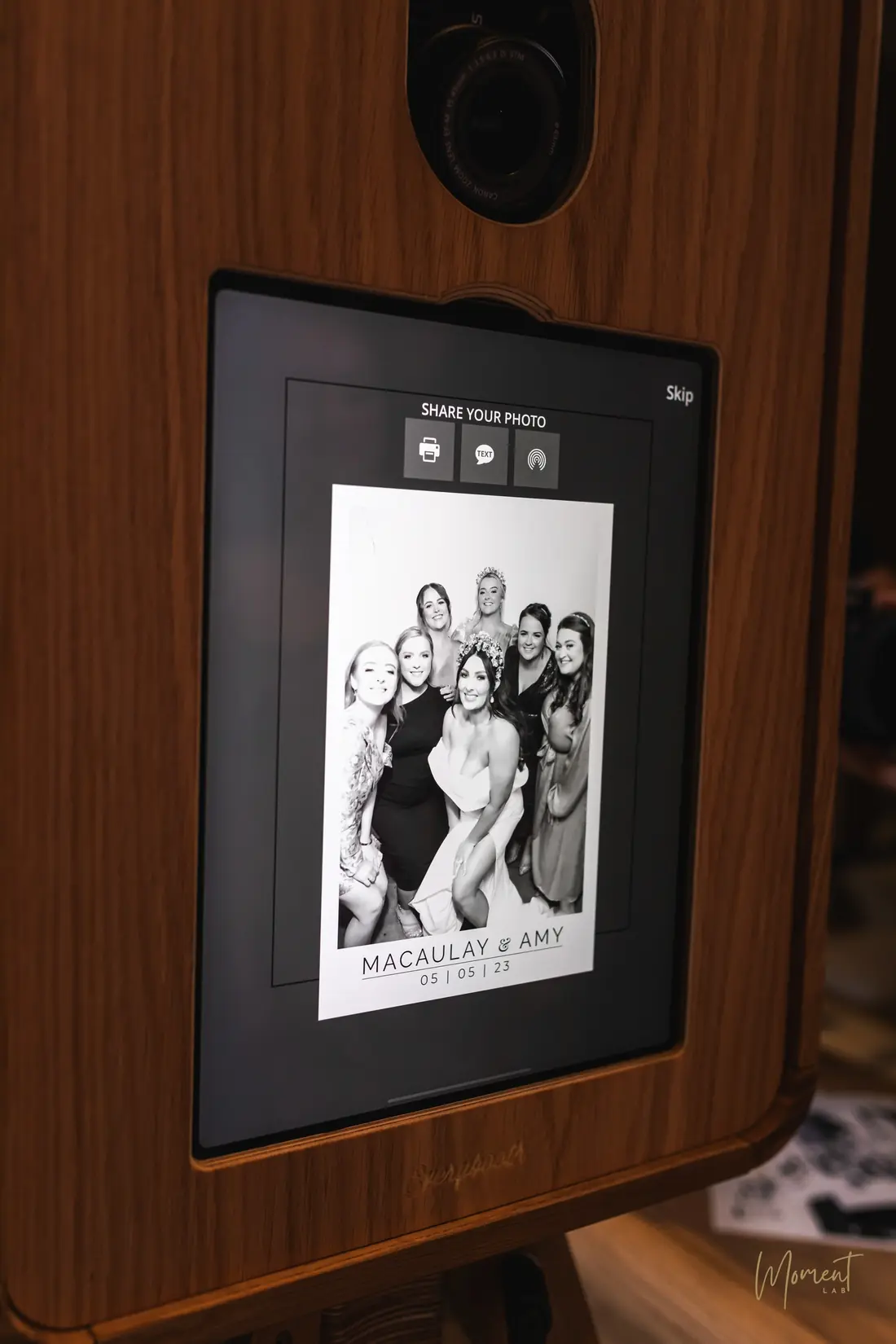 A black and white Glam portrait of a bride and her bridesmaids on the photo booth screen
