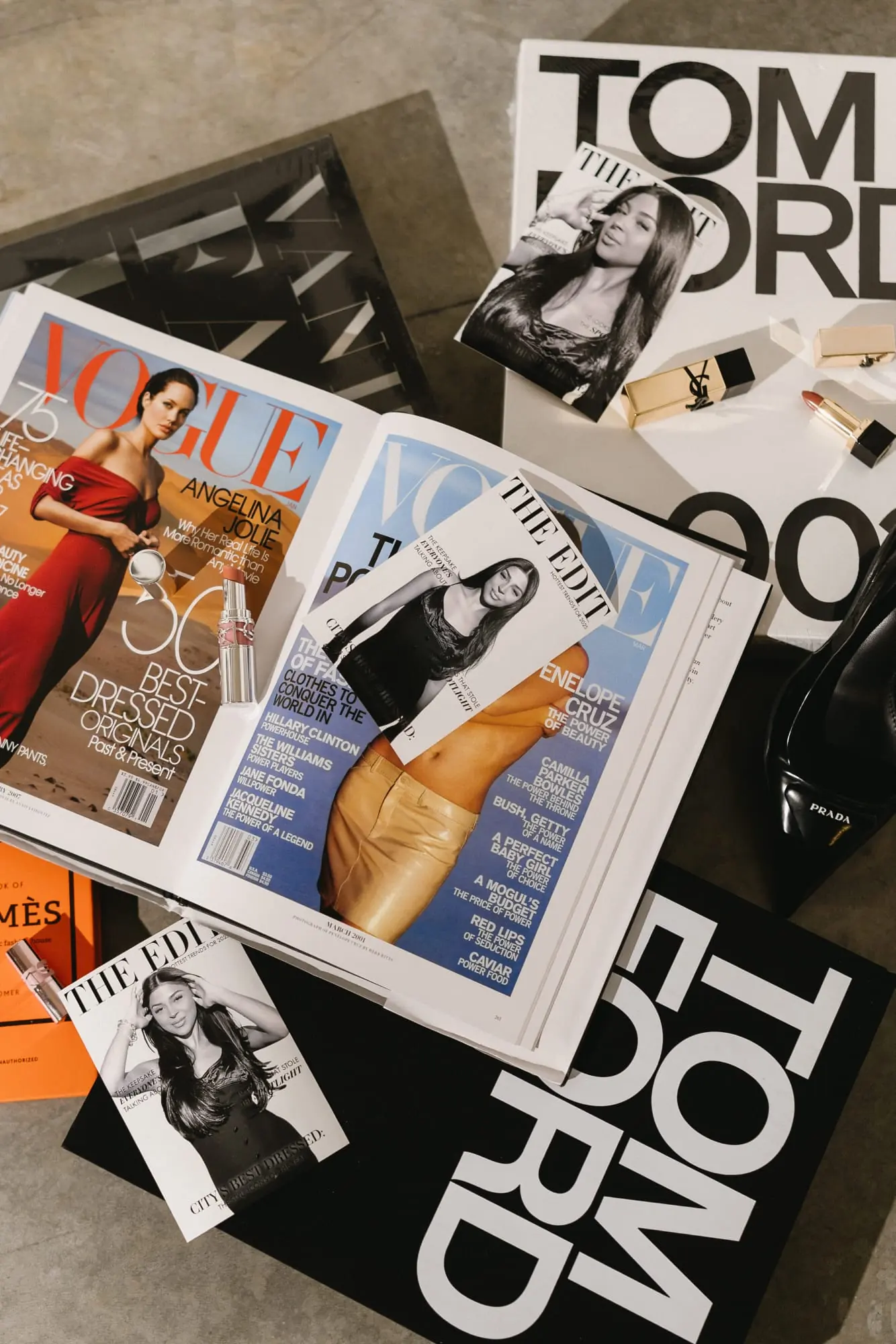Black and white magazine-style photo booth covers laid out among fashion books