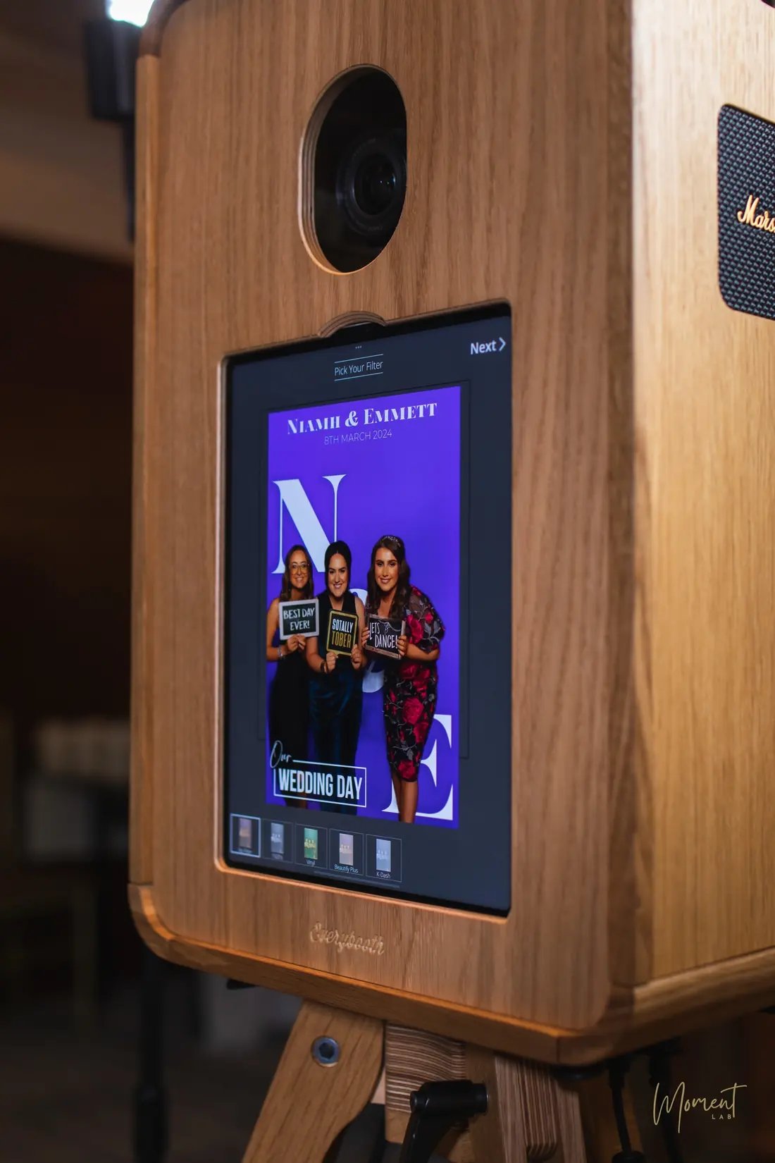 A personalised wedding magazine cover on the screen of an oak photo booth