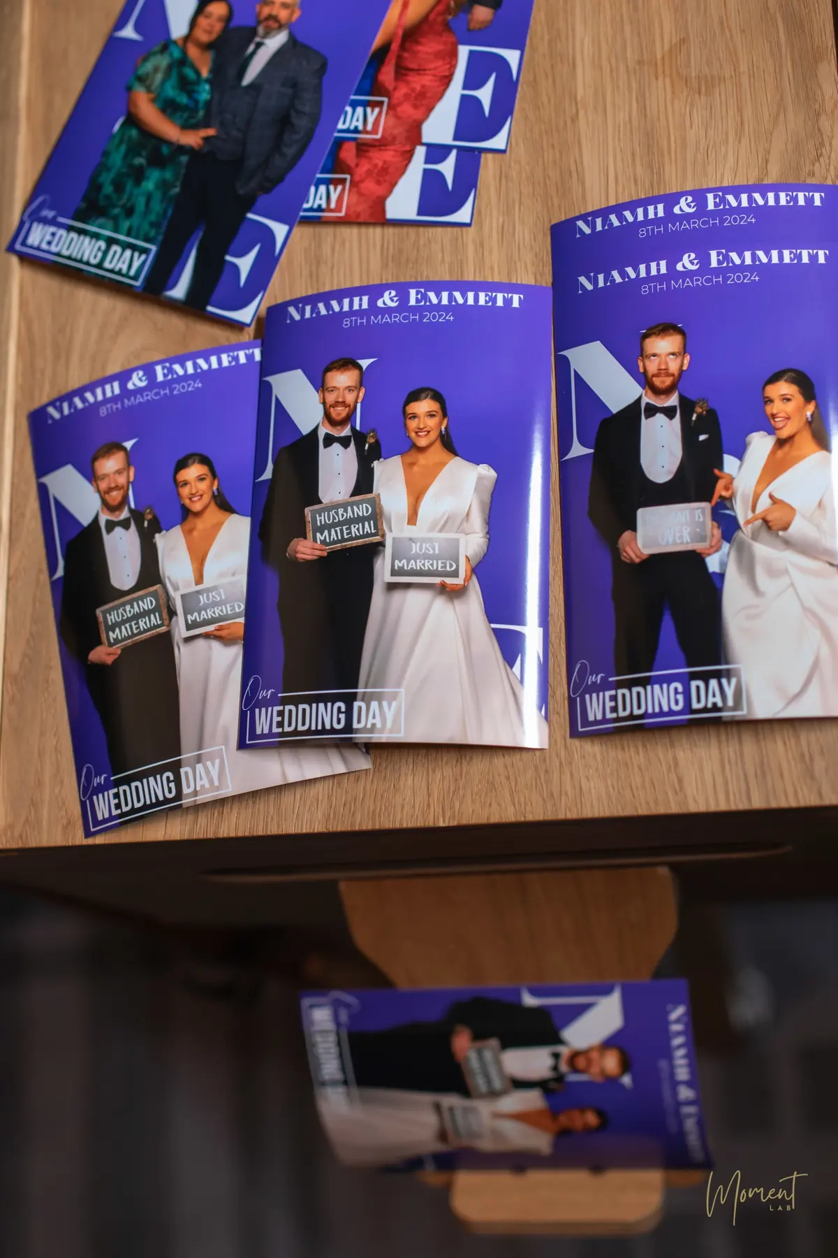 Printed wedding magazine covers of the bride and groom laid out on the booth