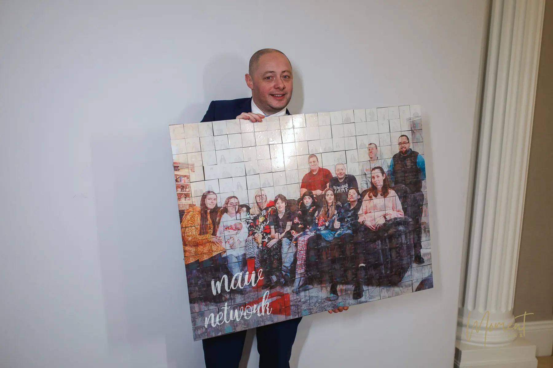 A guest holding a finished photo mosaic built from portraits taken on the night