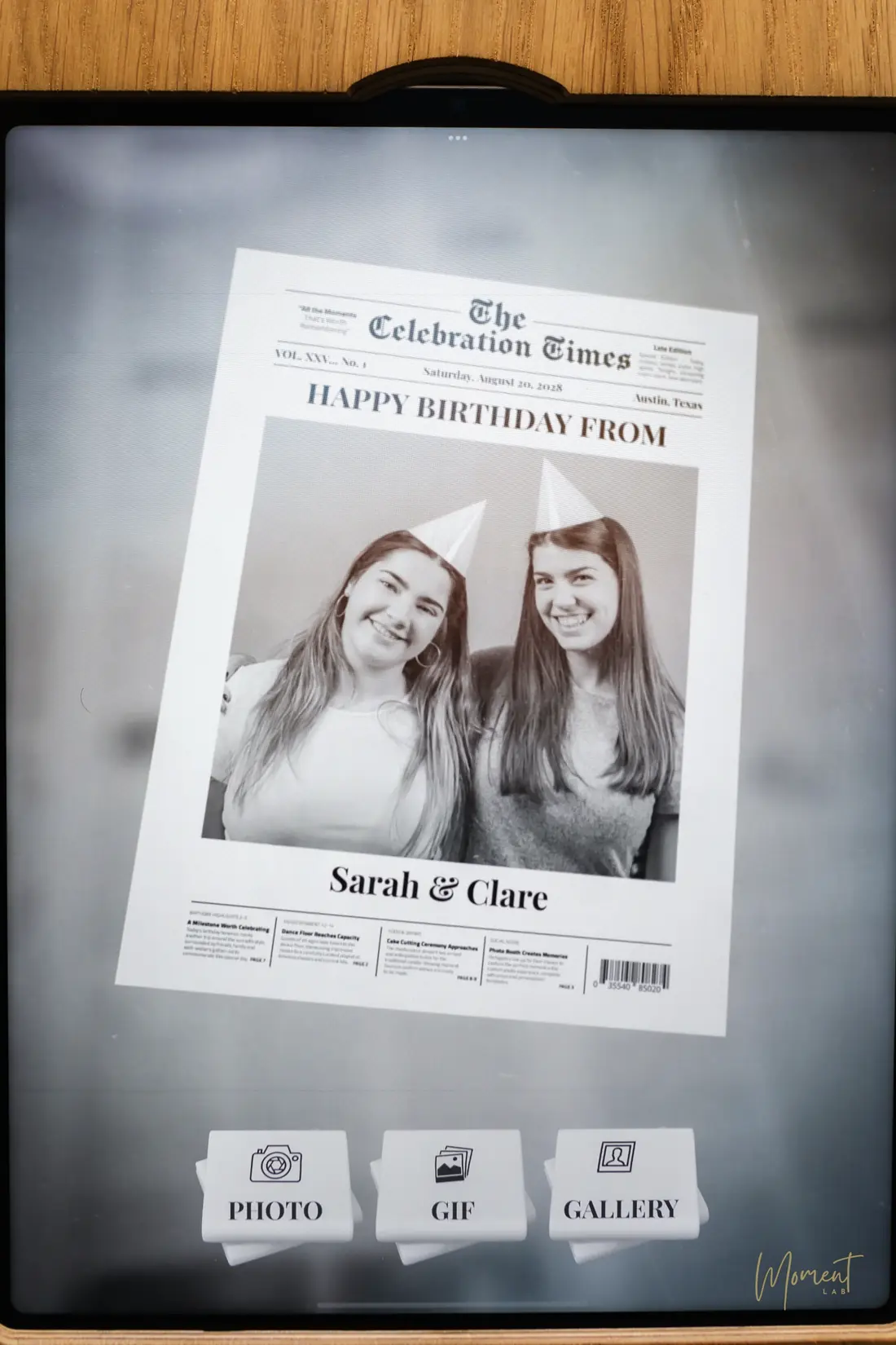 A birthday newspaper front page of two guests on the photo booth screen
