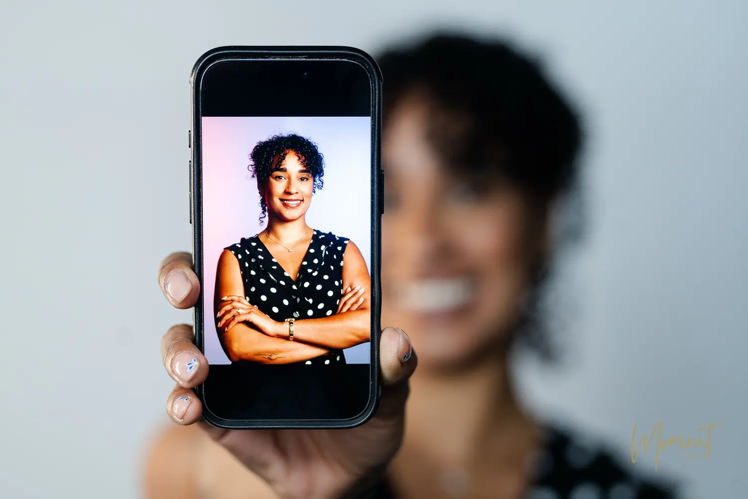 A finished professional headshot shown on a phone