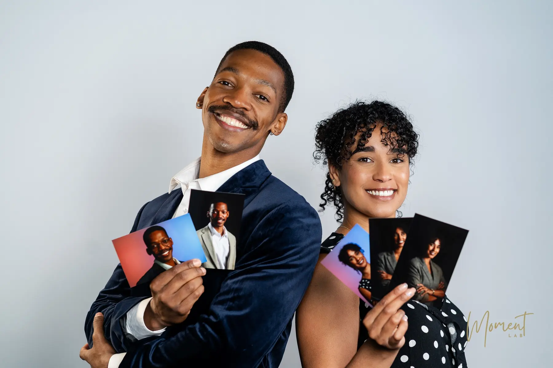Two team members holding their finished professional headshot prints