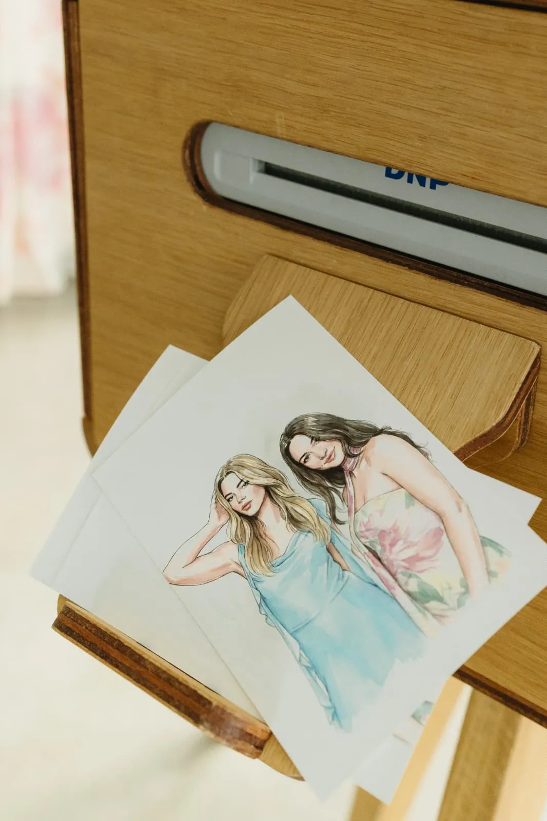 Illustrated guest portraits printing from the photo booth