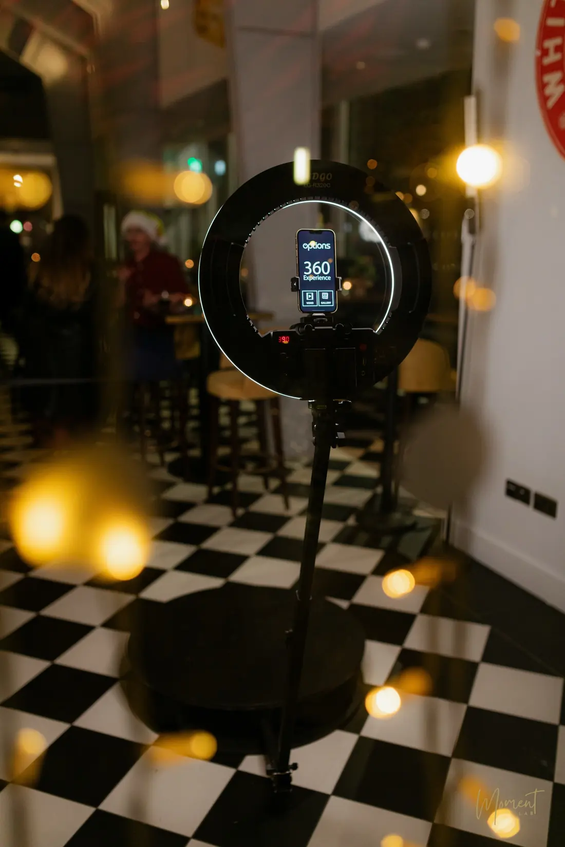 The Spin 360 video booth, with its ring light and phone on the rotating arm, ready on a chequered floor